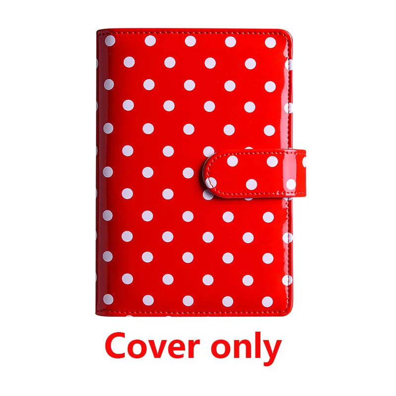 Red binder cover with white polka dots and a snap closure.