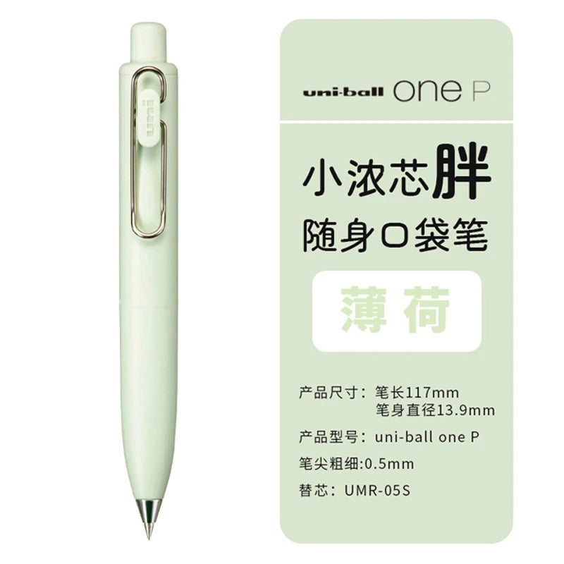 A white Uni-Ball One P gel pen is shown standing upright against a light green background.