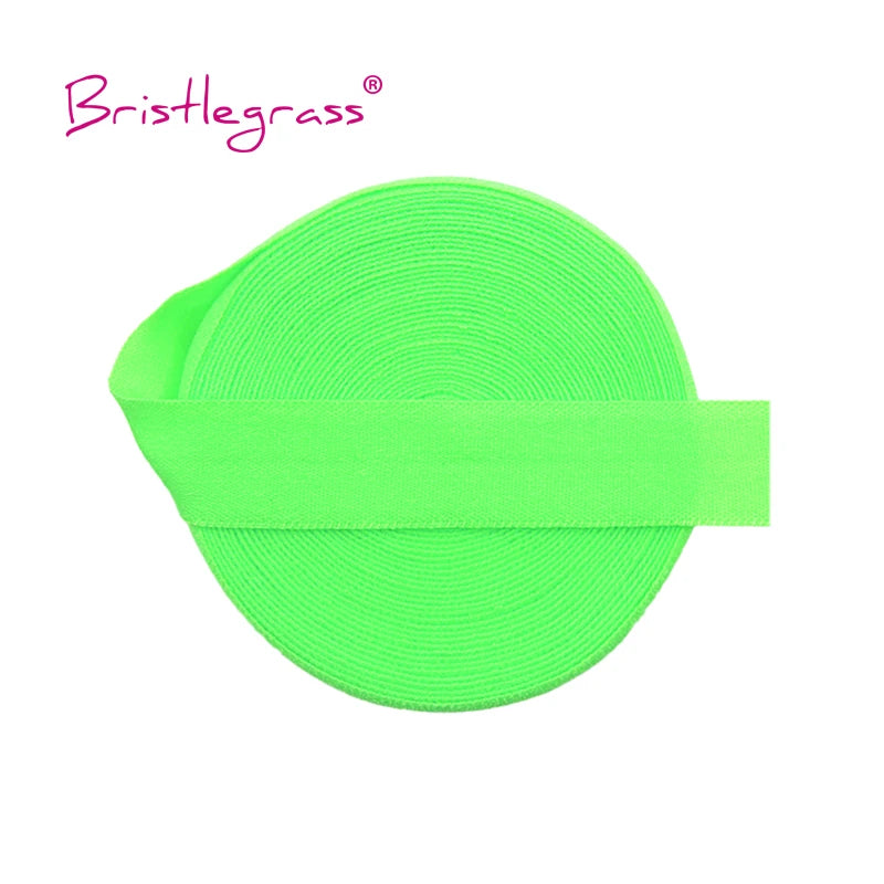 A bright lime green elastic hair tie or trim, flat and cylindrical.