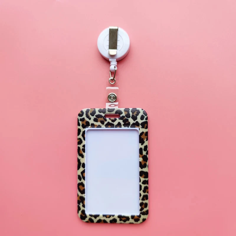 A leopard print ID holder attached to a lanyard keychain against a pink background.