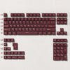 A close-up view of a dark blue PBT keycap set with cherry profile keys for a mechanical keyboard.