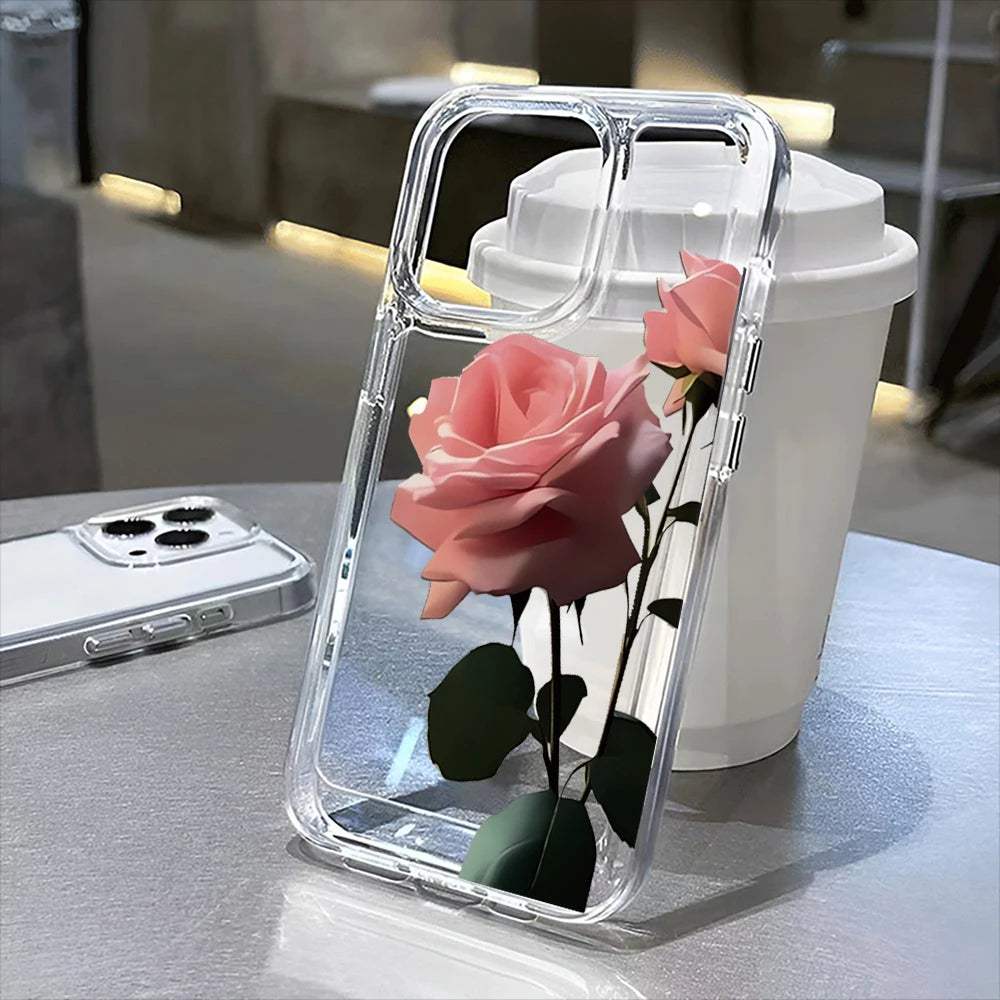A clear phone case shaped like a pink rose is displayed on a table next to a white cup.