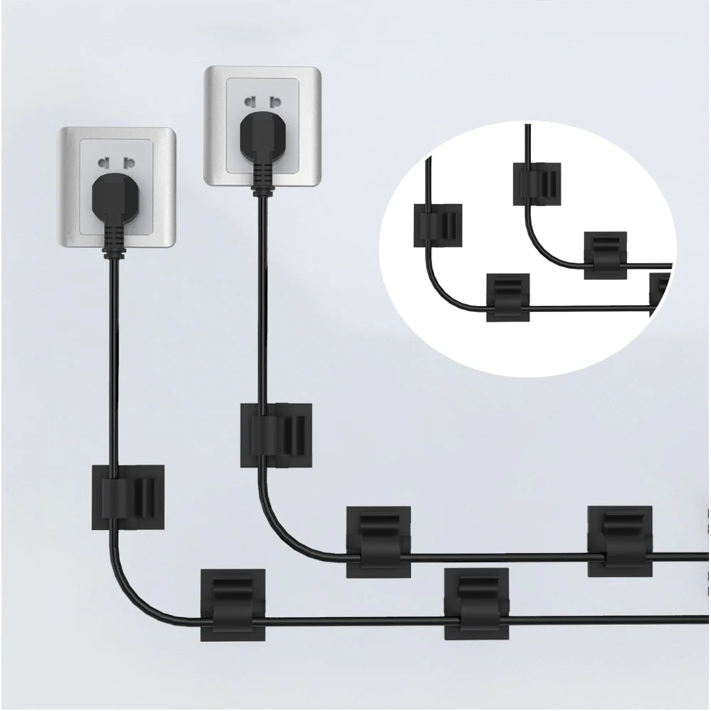 A black cable organizer kit with multiple outlets and connectors shown mounted on a wall.