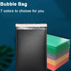 A stack of black thickened color coextrusion film bubble bags in various shades of green, purple, and orange.