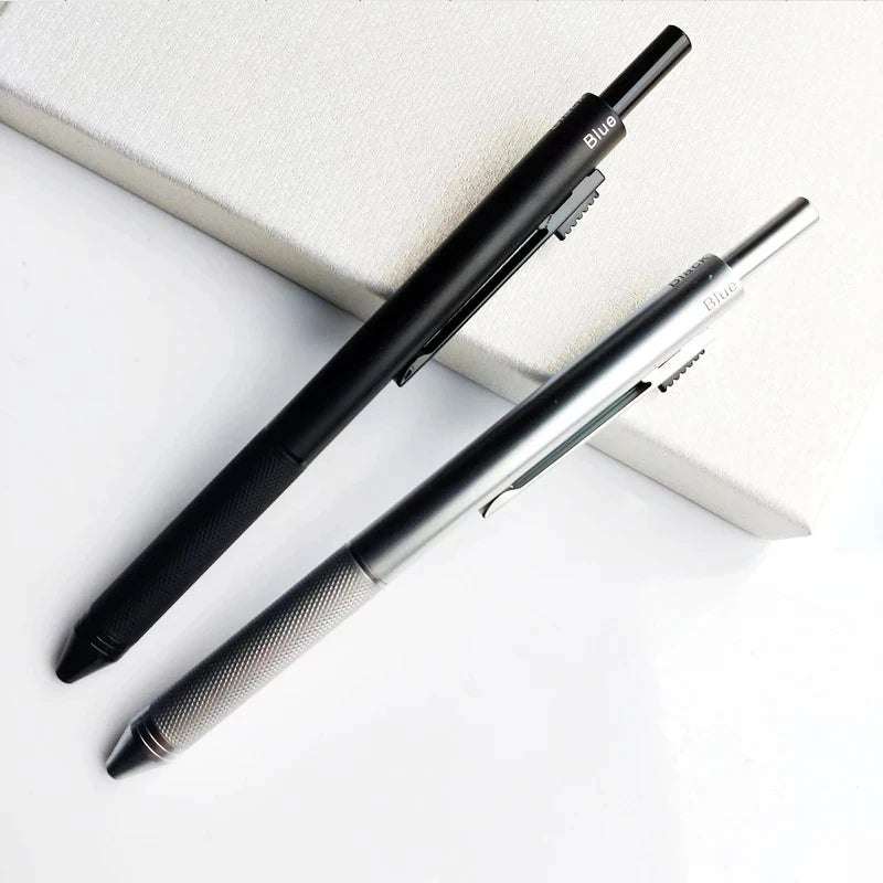 A black and silver 4-in-1 gravity sensor ballpoint pen with a mechanical pencil resting on a white surface.