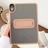 A hand holds a beige matte protective case for an iPad, showing the device's back and camera module.