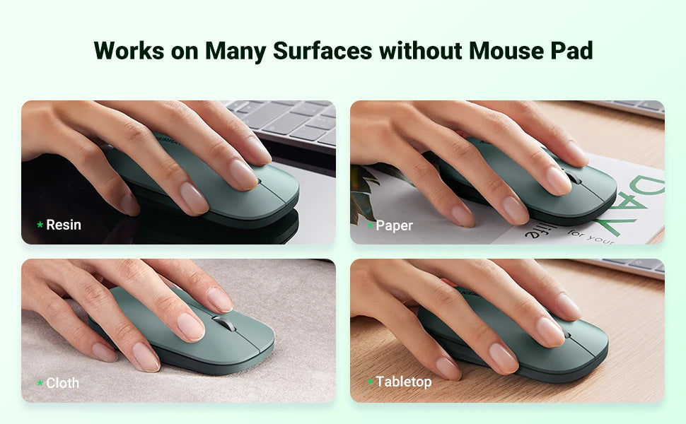 A dark gray ultra-slim wireless Bluetooth mouse is shown being used on various surfaces including a mouse pad, paper, cloth, 