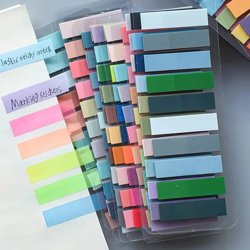 A clear plastic container filled with a 200-pack of colorful fluorescent transparent tabs and markers for organization.