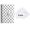 A white reusable PU leather binder with black polka dots and a clear plastic sleeve containing six sheets.