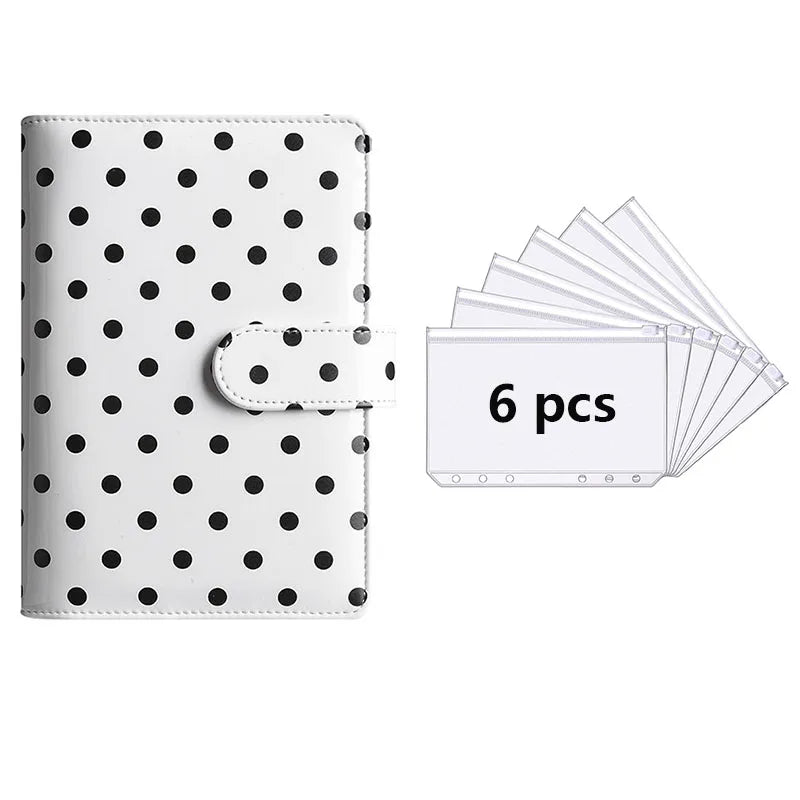 A white reusable PU leather binder with black polka dots and a clear plastic sleeve containing six sheets.