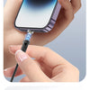 A hand is connecting a magnetic charging cable to an iPhone, demonstrating easy device charging.
