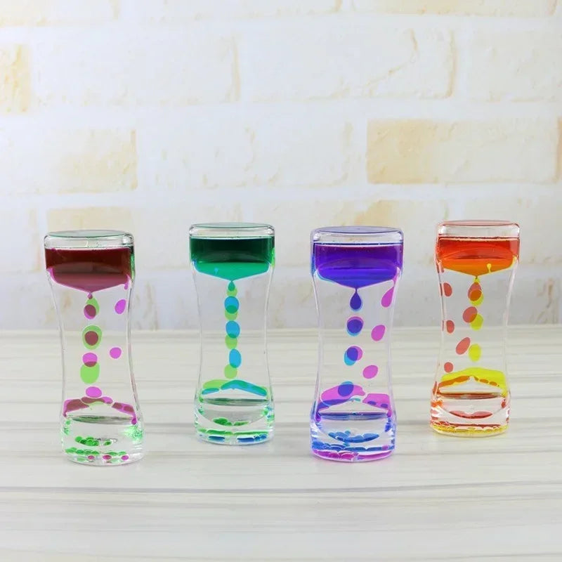 Four glass hourglass timers filled with colorful liquids demonstrating different colors and patterns.
