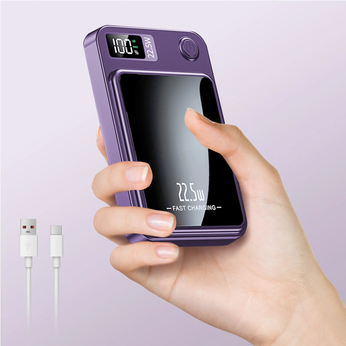 A hand holds a purple magnetic wireless power bank with a digital display showing 100% charge and fast charging indicator.