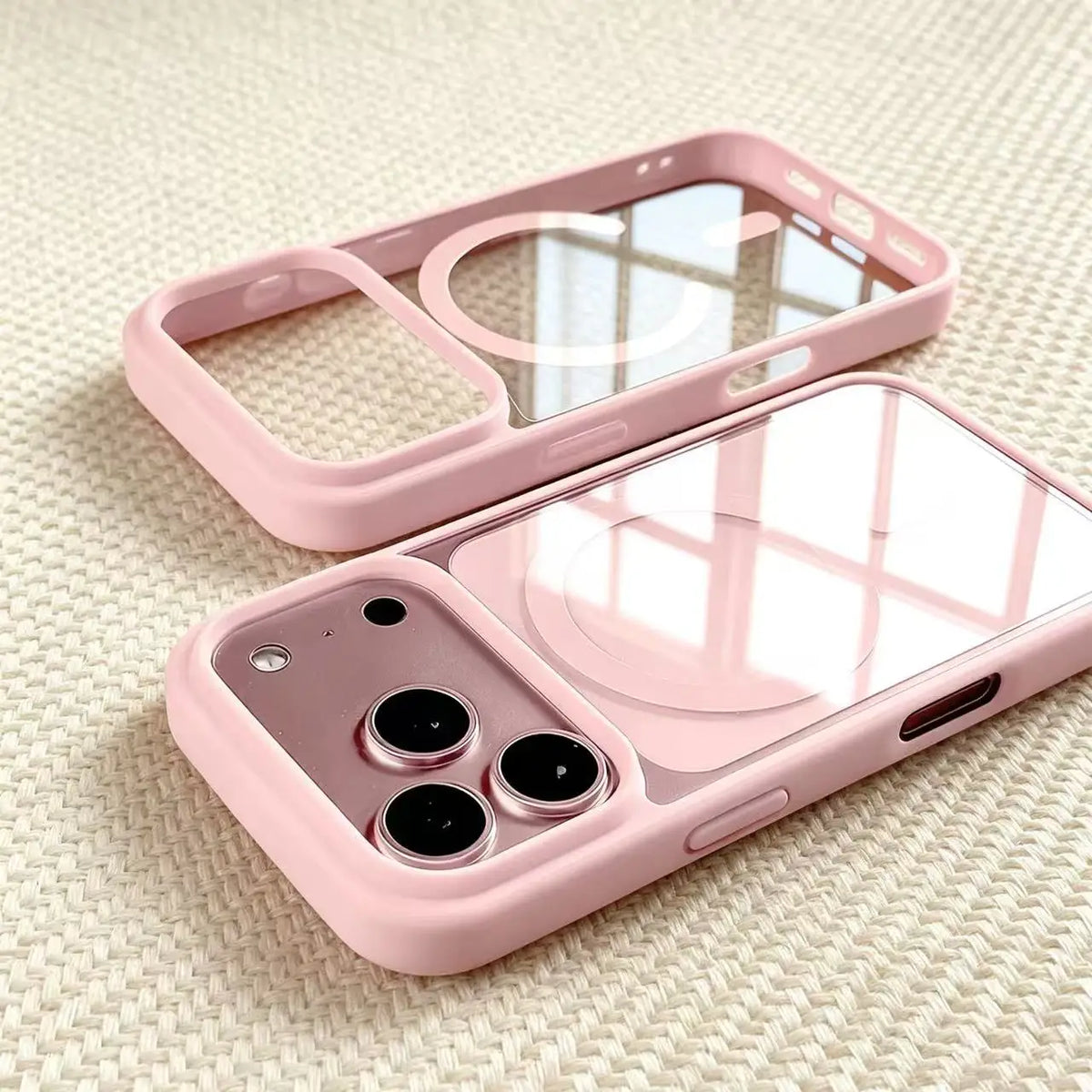 A pink transparent acrylic phone case with a protective frame and multiple camera cutouts is shown on a light background.