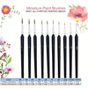 A set of miniature paint brushes in black and various sizes with pink floral accents.