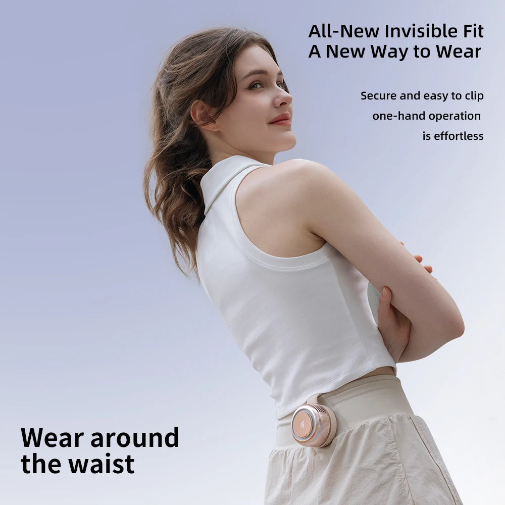 A woman wearing a white top with an invisible fit clip-on fan worn around the waist.