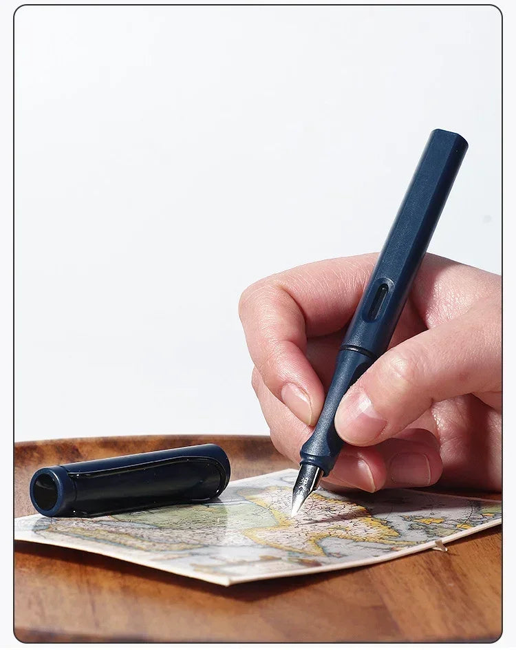 A hand holds a dark blue fountain pen writing on aged paper.