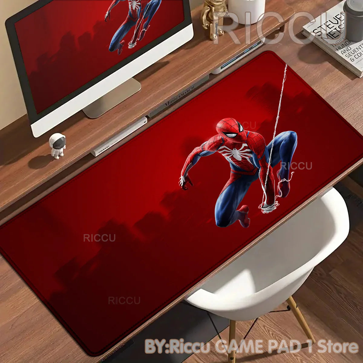 A red Spider-Man graphic desk mat featuring a superhero in a dynamic pose on a wooden desk.