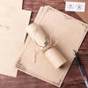 A set of vintage European style letter and invitation envelopes on brown paper with a rolled parchment inside.