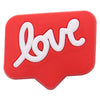 A red, heart-shaped charm with white script spelling out love.