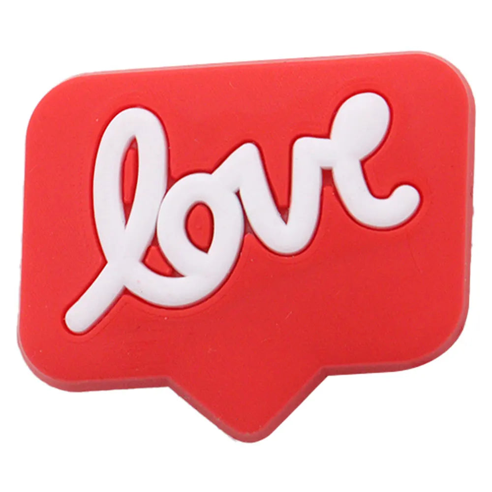 A red, heart-shaped charm with white script spelling out love.