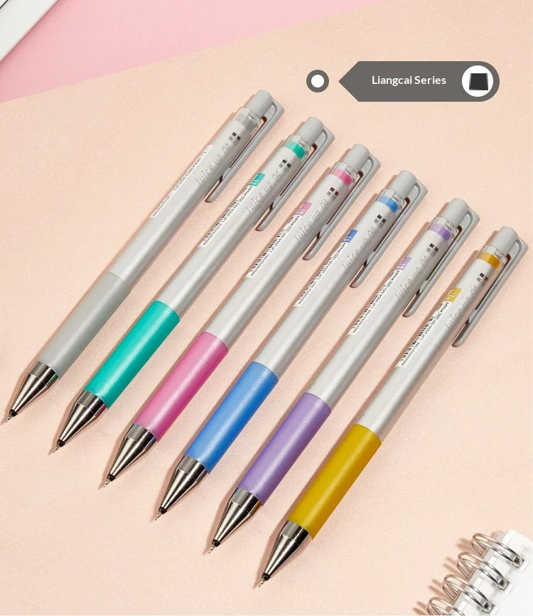A set of colorful Pilot Juice Up Fine Point Gel Pens displayed diagonally on a light pink background.