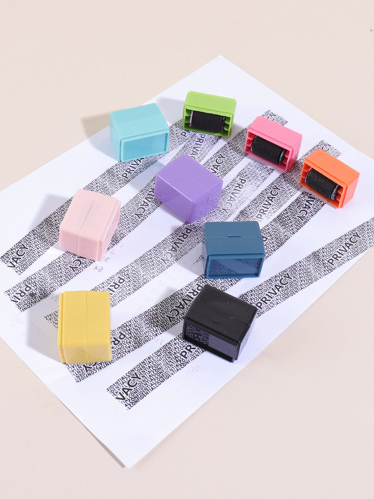 A collection of colorful privacy protection roller stamps in various shades including teal, green, pink, purple, blue, orange