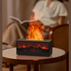 A black fireplace moulding device is shown on a wooden table, emitting bright flames and light.