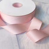 Roll of matte finish pink satin ribbon for crafts, wrapping, and decor