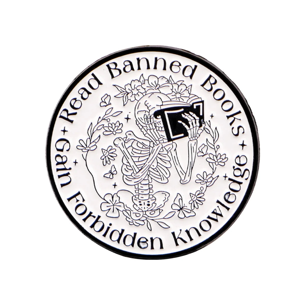 A black and white enamel lapel pin featuring a skull surrounded by flowers and the text Read Banned Books Gain Forbidden Know