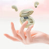 A hand holds an open mini Bluetooth earphone case with a glowing display, showing the earphones inside.