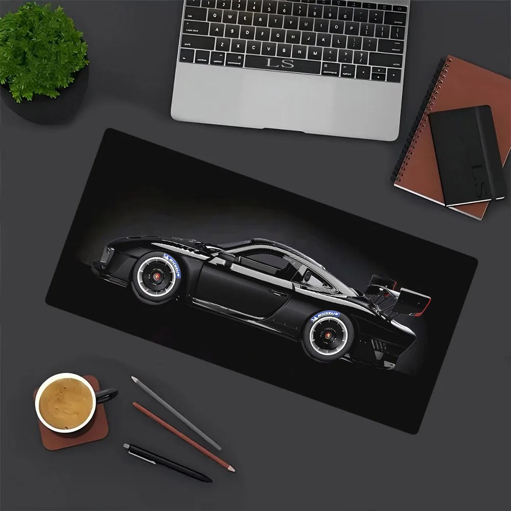 A black JDM car design gaming mouse pad featuring a detailed model of a black sports car.