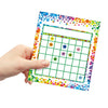 A hand holds an incentive reward chart for kids behavior tracking with a grid and colorful confetti border.