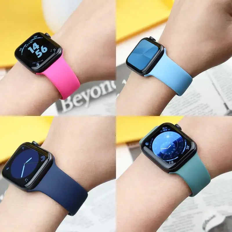 A collection of silicone sport bands in various colors, including pink, light blue, and dark blue, shown on wrists.