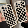A pair of black and white checkered silicone phone cases displayed on a hand.