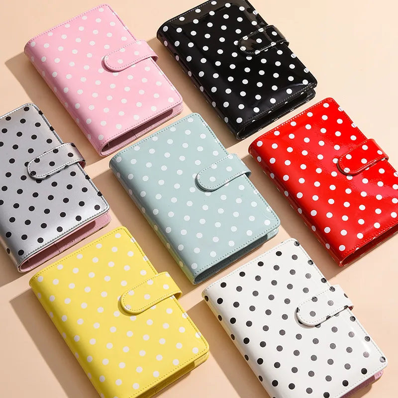 A collection of colorful reusable PU leather binders with cash pockets in various polka dot patterns.