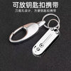 A compact stainless steel pocket knife with a keyring attached, shown against a dark background.