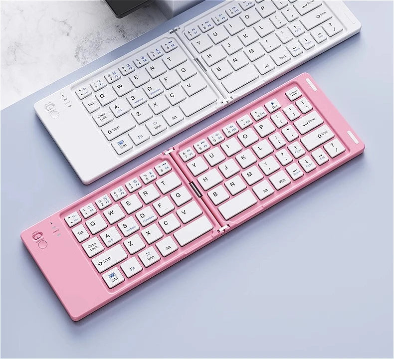 A pink foldable Bluetooth keyboard is shown open and closed on a light blue surface.