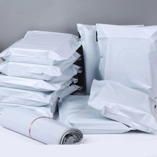 A stack of white self-sealing waterproof shipping bags, some rolled up.