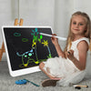 A young girl is using an interactive LCD writing tablet to draw a giraffe on a black screen.