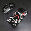 A black phone case featuring a white leopard print design with red accents, next to a black Apple AirPod case.