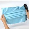 Hands holding a light blue reusable waterproof poly shipping bag.