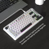Teclado compacto de membrana blanco con iluminación RGB y perilla giratoria sobre una superficie oscura.