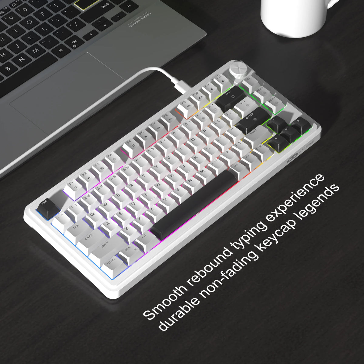 Teclado compacto de membrana blanco con iluminación RGB y perilla giratoria sobre una superficie oscura.