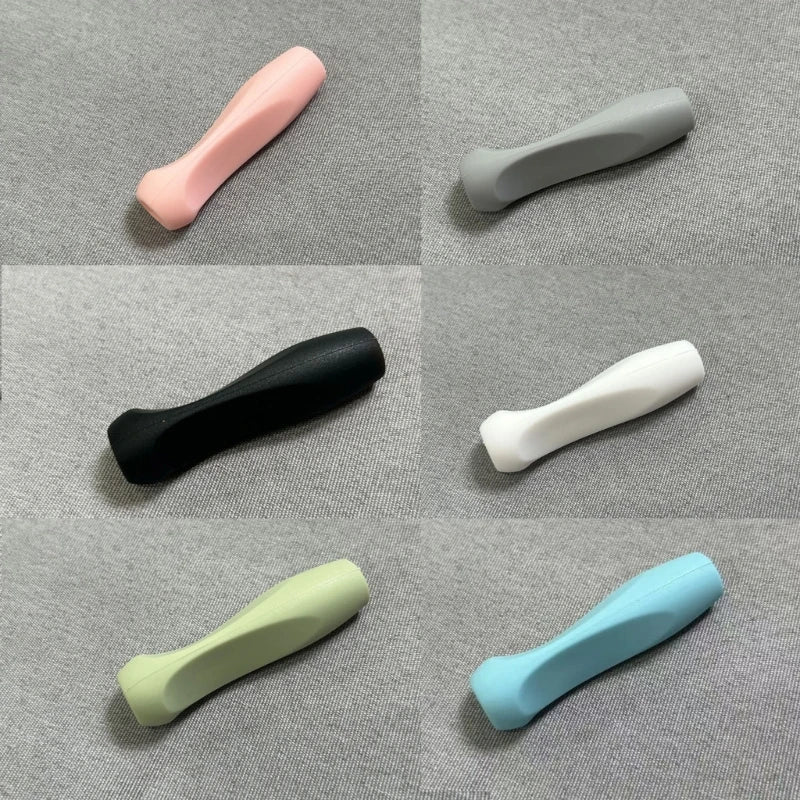 A collection of silicone pen grip sleeves in various colors including pink, gray, black, white, green, and light blue.