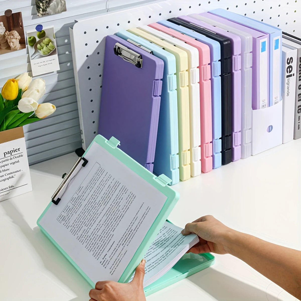 A collection of colorful A4 document and photo storage file boxes lined up on a white desk.