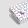 A close-up view of white custom printed jelly keycaps for a mechanical keyboard, showing various letter and function keys.