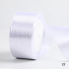 A roll of white satin ribbon used for gift wrapping and DIY crafts.