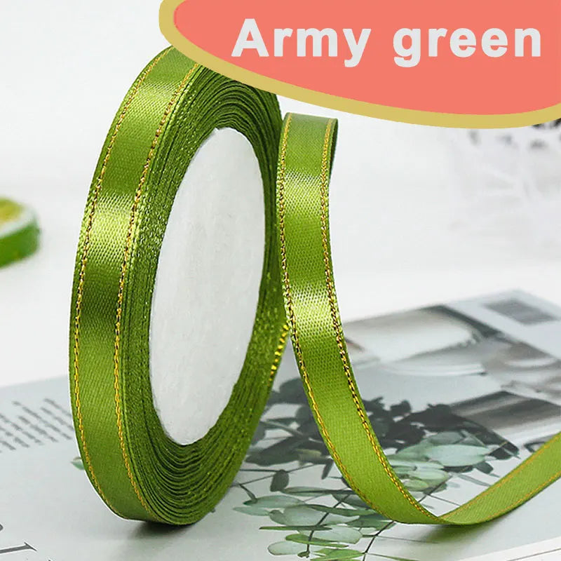 Army green satin ribbon rolled on and unrolled, showing a gold edge.