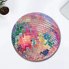 A pink disco ball mouse pad with a non-slip rubber base, featuring a mosaic of iridescent colors.